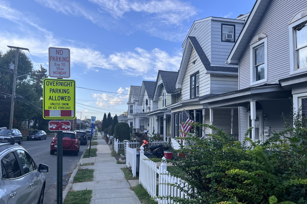Rockland County Murder Trial Witness story context: quiet residential street with parked cars, homes, and parking signs