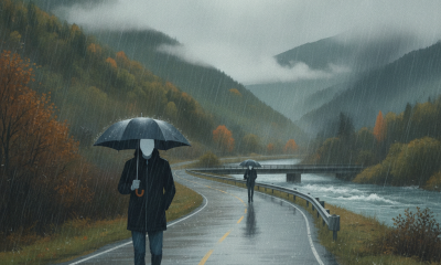 Two figures walking along a rain-soaked road in a mountainous landscape, one holdi — Bennington County VT weather forecast