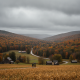 Two people walking on a path through a colorful autumn landscape in Bennington Valley und — Bennington VT weather forecast
