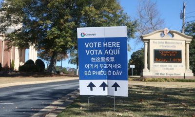 DHS voter investigations naturalized citizens story context: multilingual Gwinnett “Vote Here” sign outside a church p…