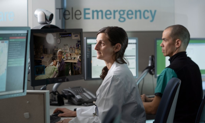 Healthcare professionals monitor patients through telemedicine screens in a clinic — September jobs report hiring slowdown