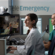 Healthcare professionals monitor patients through telemedicine screens in a clinic — September jobs report hiring slowdown