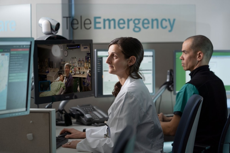 Healthcare professionals monitor patients through telemedicine screens in a clinic — September jobs report hiring slowdown