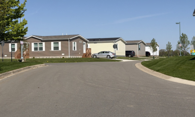 Manufactured homes line a quiet residential street beneath a clear b — 21st Century ROAD to Housing Act manufactured homes
