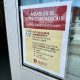 A sign warning about the contagious nature of measles, instructing people to wear masks and check — US measles cases 2025
