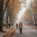 Bennington County Halloween weather: people walk a foggy, leaf-strewn street beneath orange autumn trees, one walking a dog.