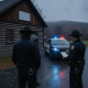 Two police officers speaking with a person near a police car with flashing lights outside a log — shaftsbury vt dui arrest