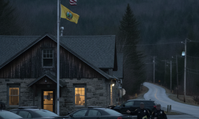 Two Vermont State Police officers walk near their barracks in Shaftsbury, V — Shaftsbury VT domestic assault investigation