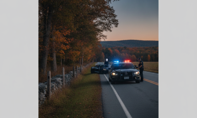 Vermont State Police Shaftsbury Barracks patrol cars with flashing lights on a rural road at dusk